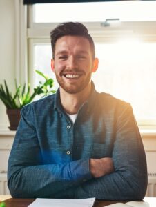 smiling-happy-successful-businessman-e1629774005703.jpg
